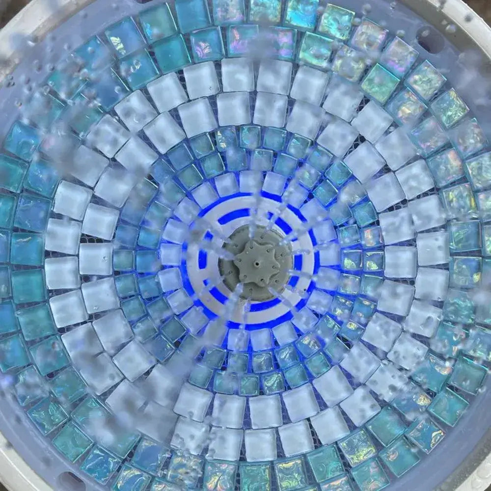 Mosaic pattern with blue and gray tiles arranged in a circular design.