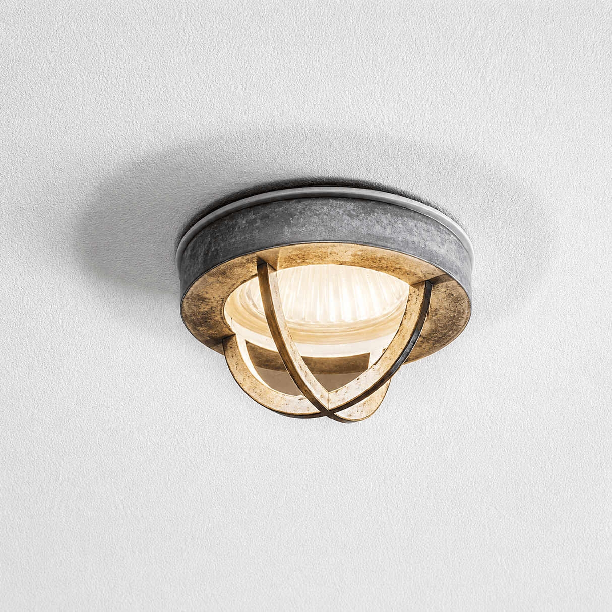 Ceiling light fixture with metallic design on a white ceiling