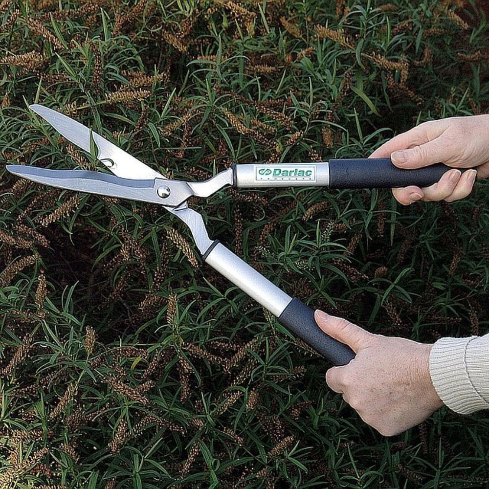 lightweight ladies shears someone holding them clipping a bush