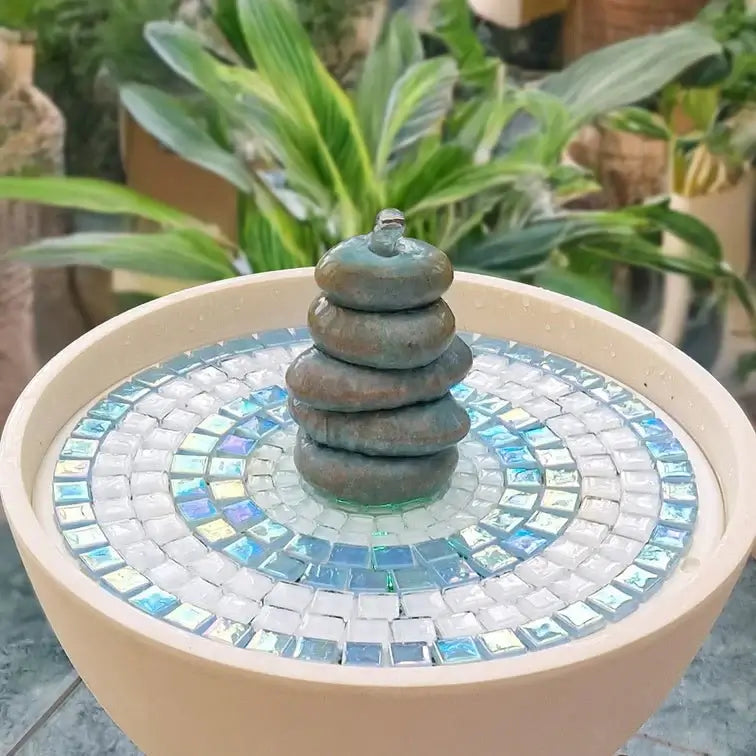 Mosaic water fountain with stacked pebbles