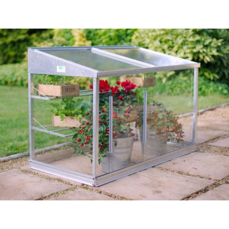 Small coldframe in garden with plants in it
