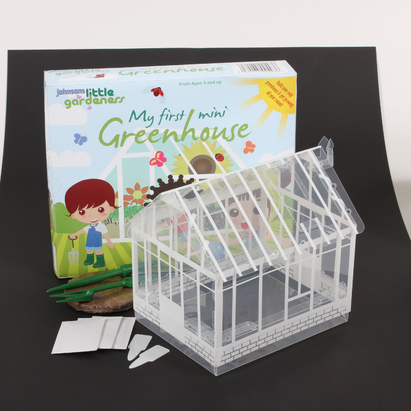 Children's Mini Greenhouse Kit including seeds, soil, and gardening tools.