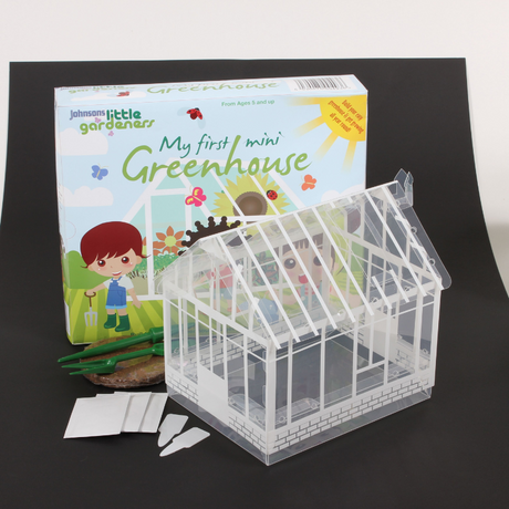 Children's Mini Greenhouse Kit including seeds, soil, and gardening tools.