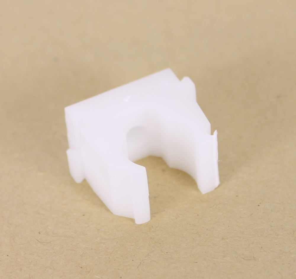 A white plastic clip designed to secure carrot fence netting to a pole.
