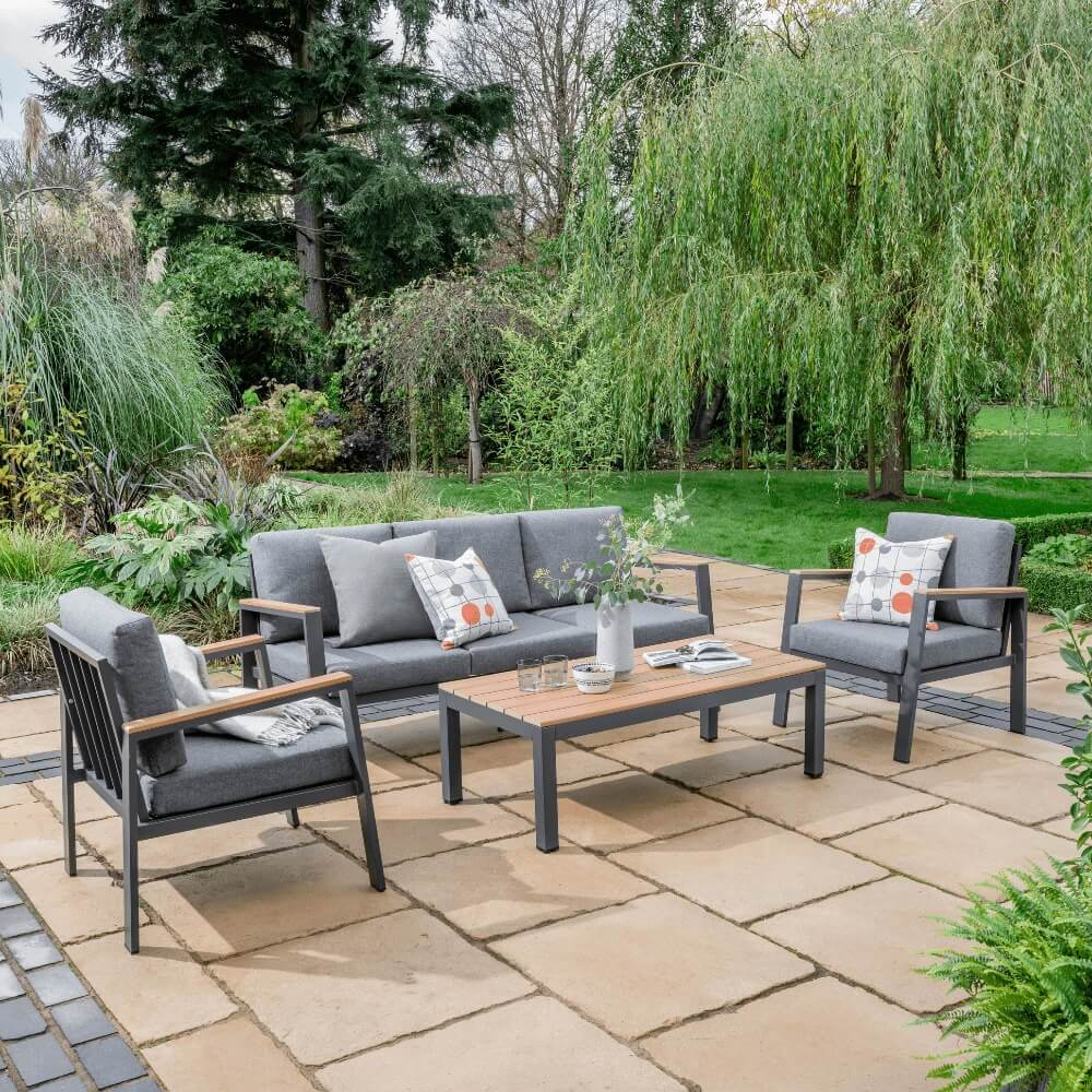 A grey couch with two pillows resting on it