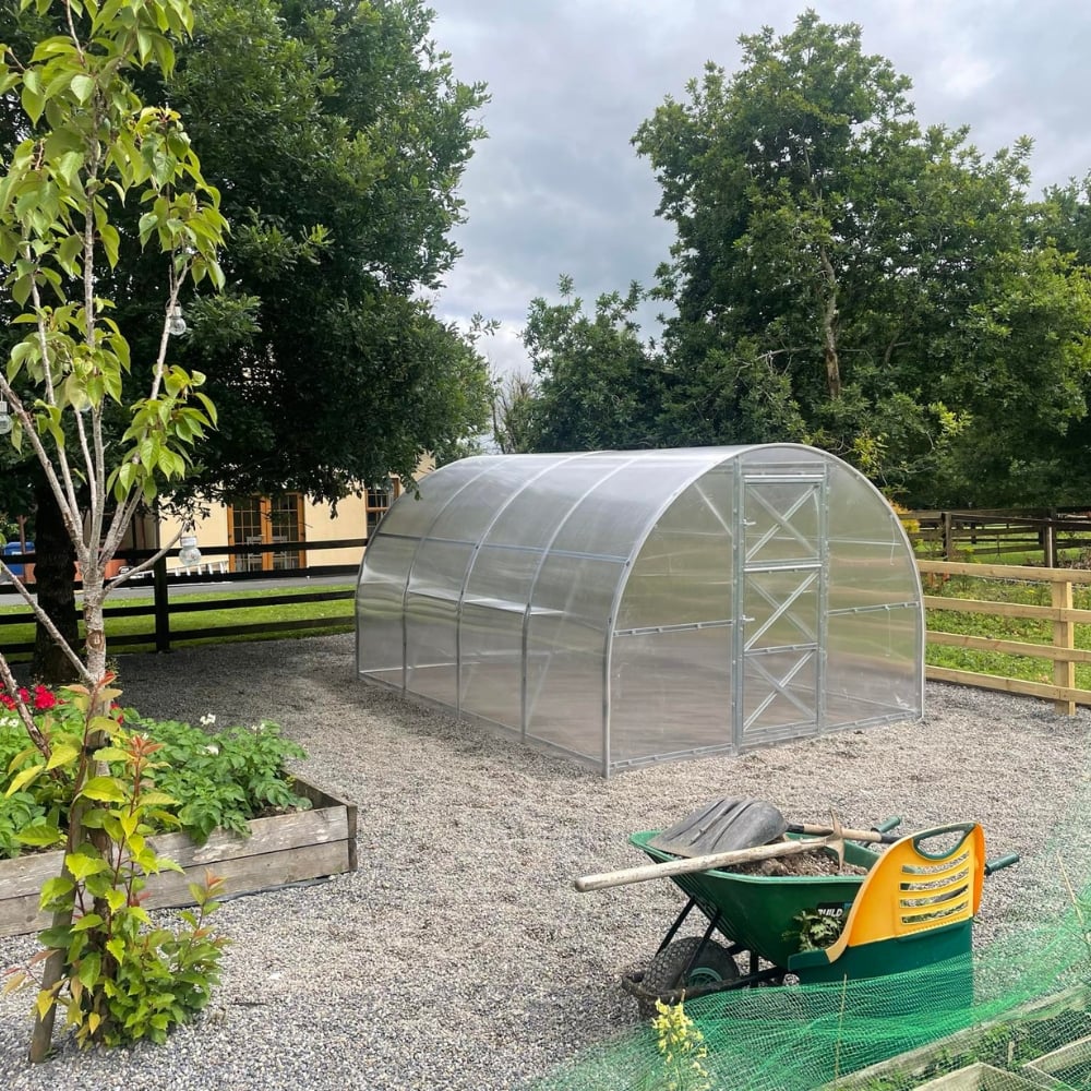 Large polytunnel with door in garden