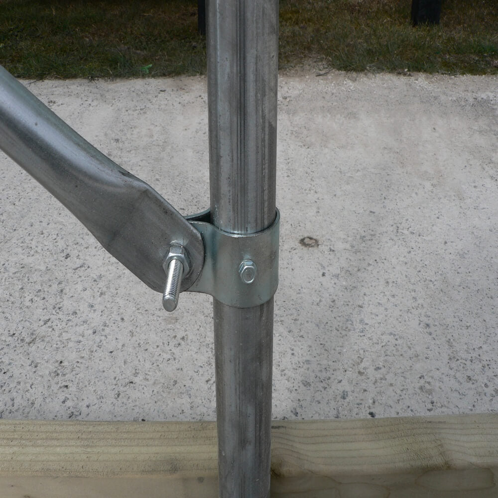 Metal pole with horizontal bar on a concrete surface
