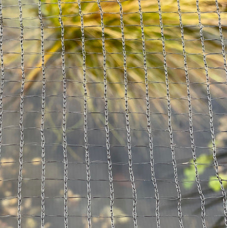 Close-up of black pond netting with a mesh size suitable for protecting fish from cats and birds, and preventing debris from entering the pond.
