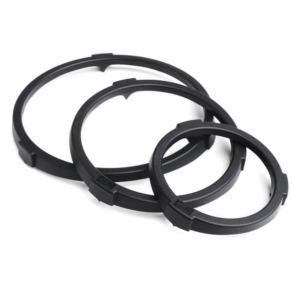 Three black Pot-Mate plant pot spacers in different sizes, designed to elevate flower and plant pots off the ground.