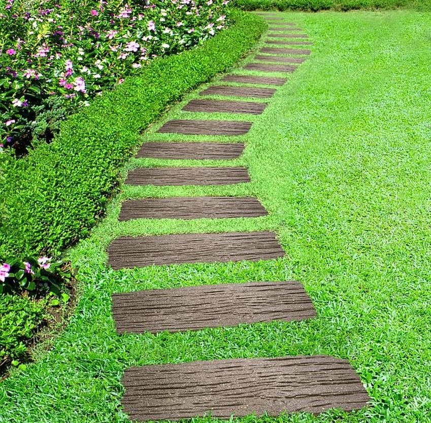 Railroad stepping stones on a grass lawn