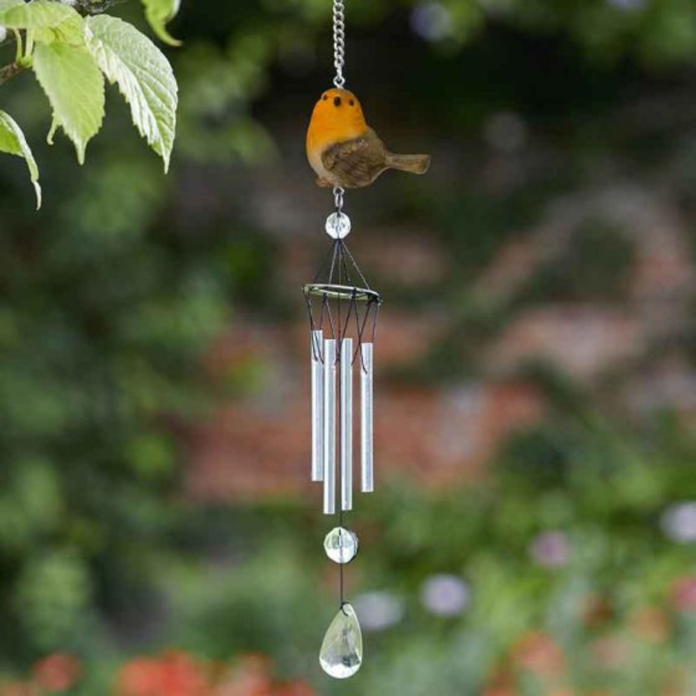 A garden wind chime featuring a hand painted red-breasted robin perched atop a metallic wind chime with glass beads.