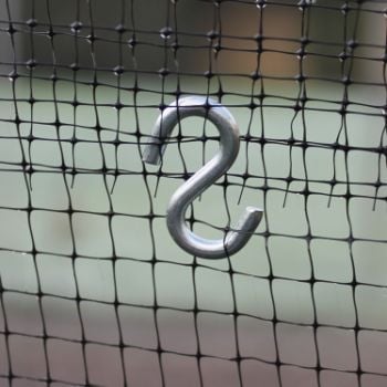 A silver metal 'S' hook attached to a black mesh netting