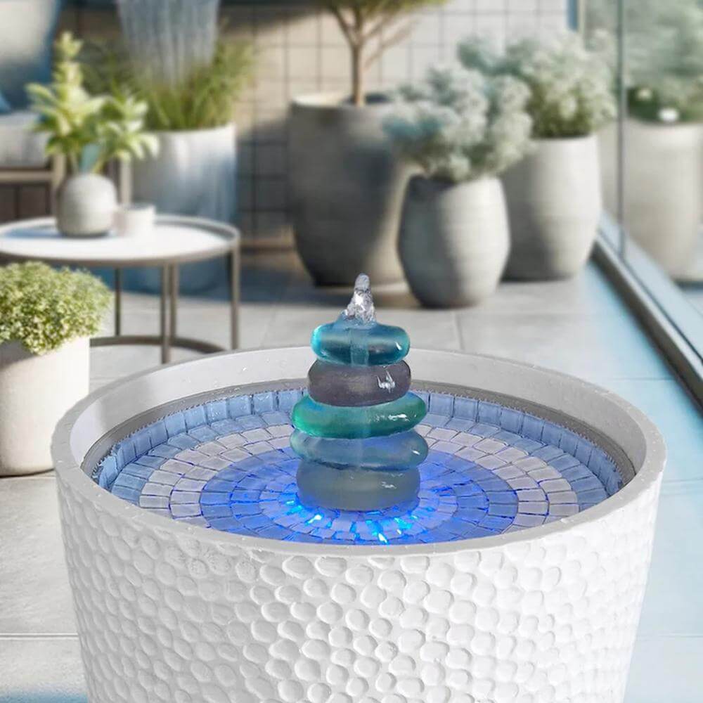 Decorative outdoor fountain with blue mosaic base