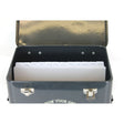 A set of white paper dividers with monthly labels, placed inside a black metal seed tin with a lid.