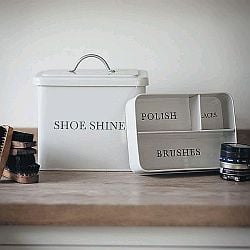 An off white chalk shoeshine box with 'SHOE SHINE' printed on the side.