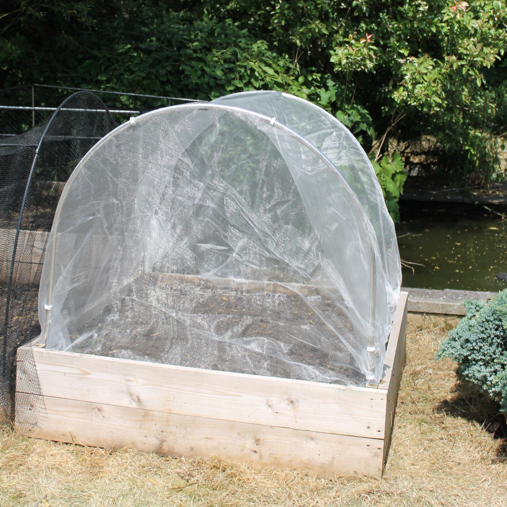 High top hoops with veggiemesh on in garden