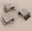 Three silver stainless steel sprung greenhouse glass clips