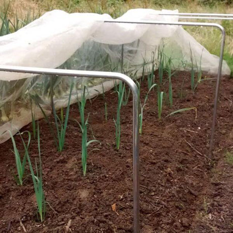 A garden tunnel kit with square aluminium hoops and a white netting covering