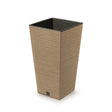A tall square brown/natural plant pot made from a combination of recycled plastic and natural wood, with a black plastic insert at the bottom.