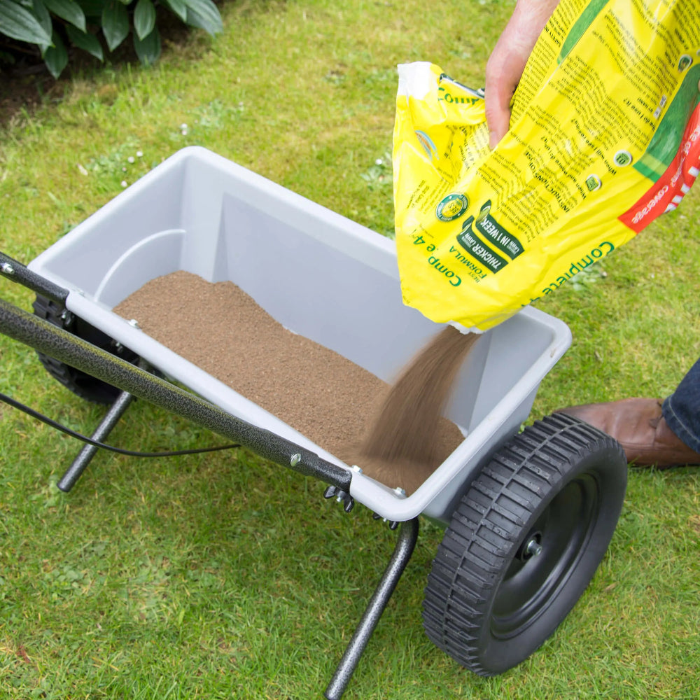 metal and plastic drop spreader with wheels