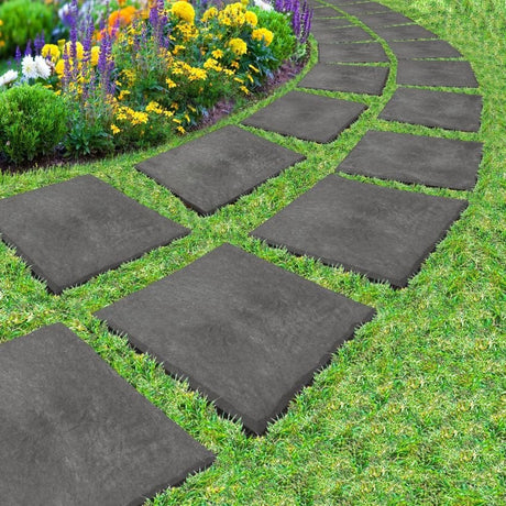 A series of gray stepping stones placed on grass