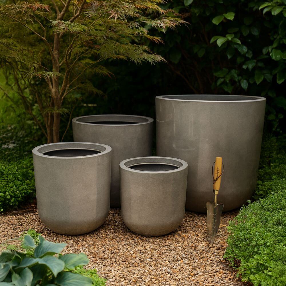 different sizes of large grey flower pots in the garden
