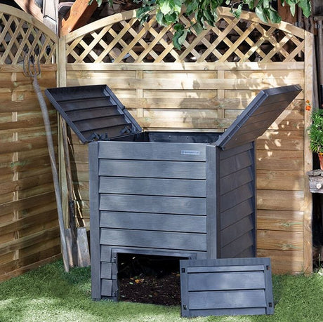 Composter in garden with lid up and front door off