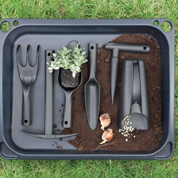 A set of black gardening tools including a dibber, fork, cup scoop, transplanting trowel, hand trowel, and pickaxe