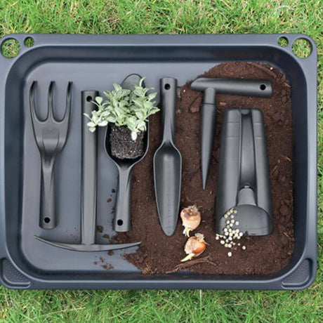 A set of black gardening tools including a dibber, fork, cup scoop, transplanting trowel, hand trowel, and pickaxe