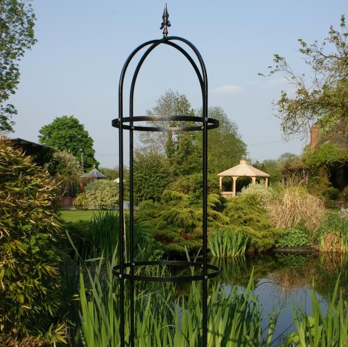A black steel obelisk garden feature
