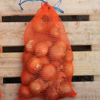 Orange vegetable nets filled with onions, tied at the top, resting on a wooden surface.