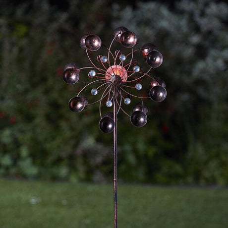 Windspinner in dark garden showing the lights