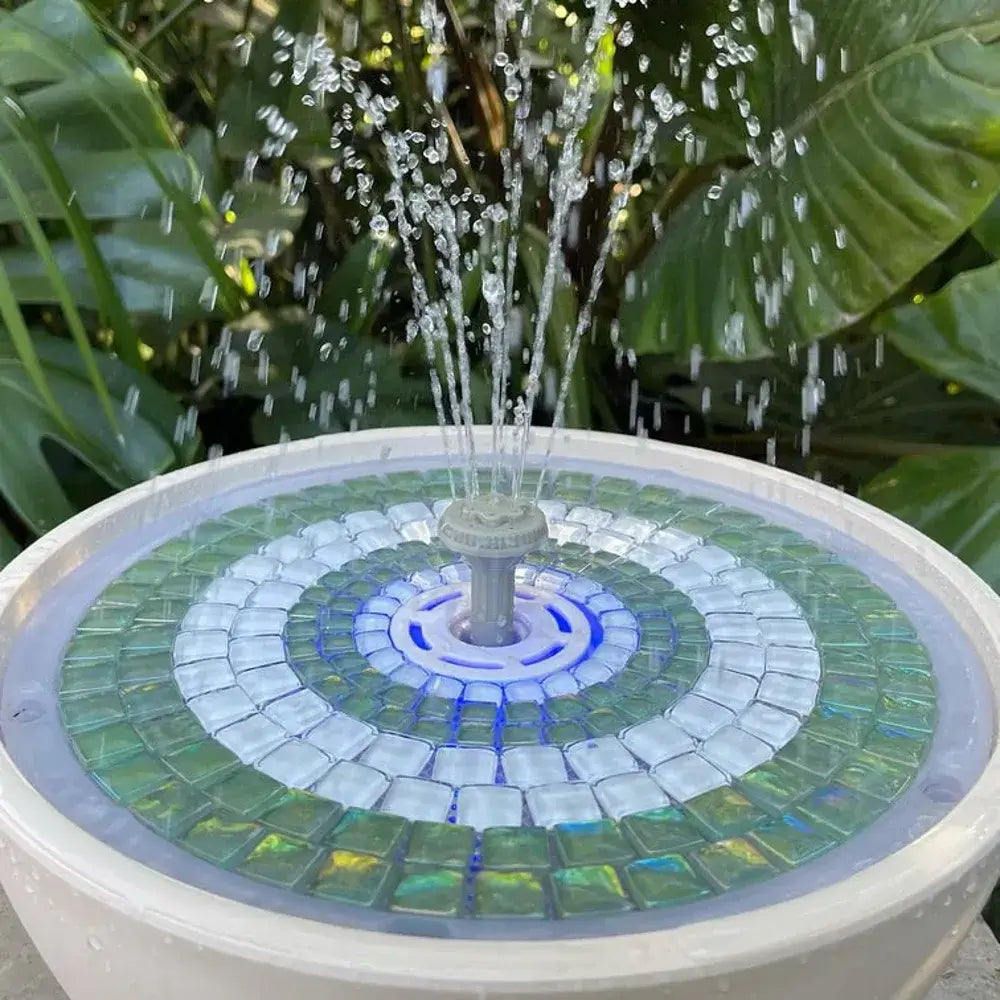 Verdigris mosaic water fountain and water being sprayed