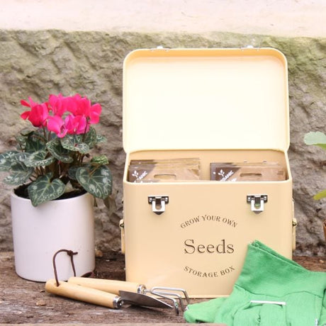 Cream seed tin with pot plant and tools