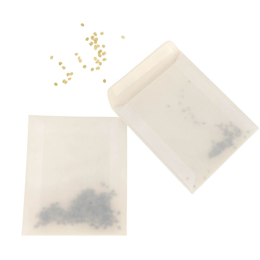Seed envelopes with loose seeds on a white background