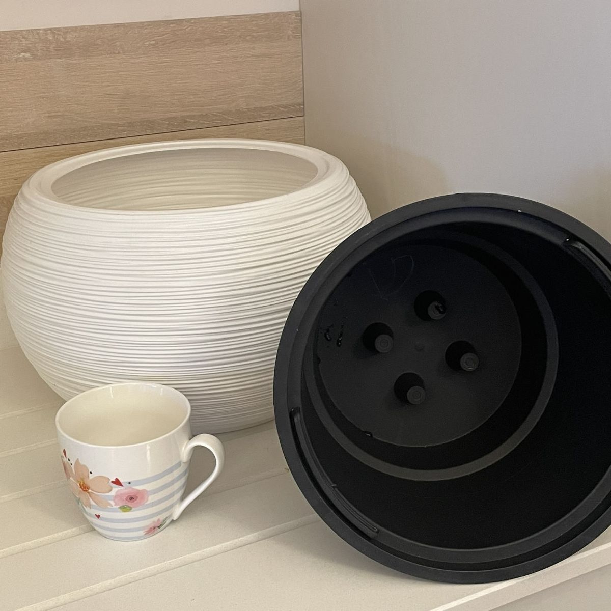 white round flower pot with insert and mug to show proportion of size