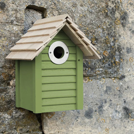 green wooden nesting box on wall