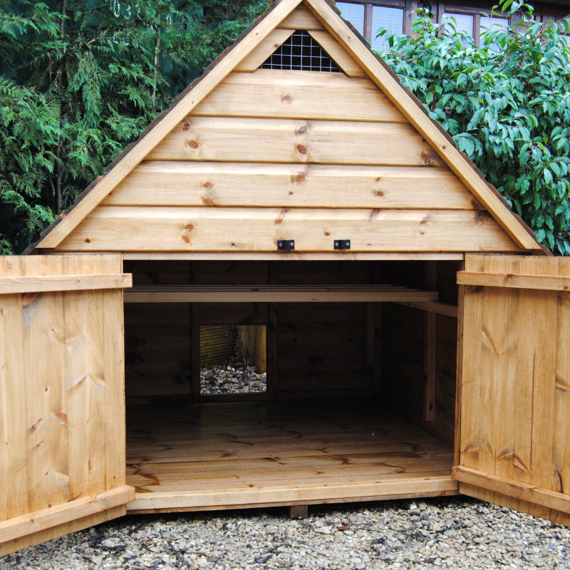 chicken house in a garden with doors open showing inside