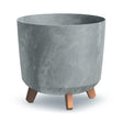 A grey concrete effect plant pot with wooden looking legs.