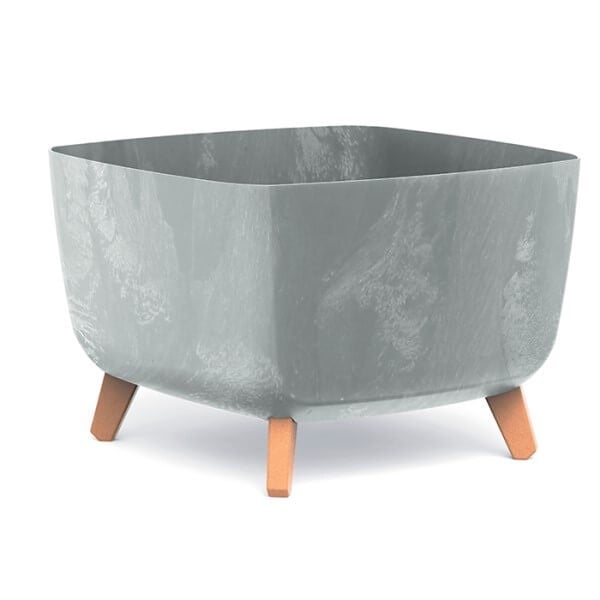 Two square concrete effect plant pots on a wooden deck, one larger than the other, with plants inside.