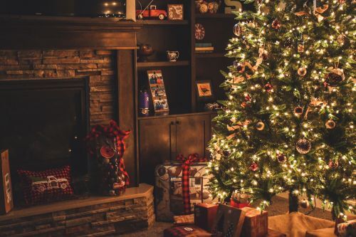 Christmas tree with presents by a fire