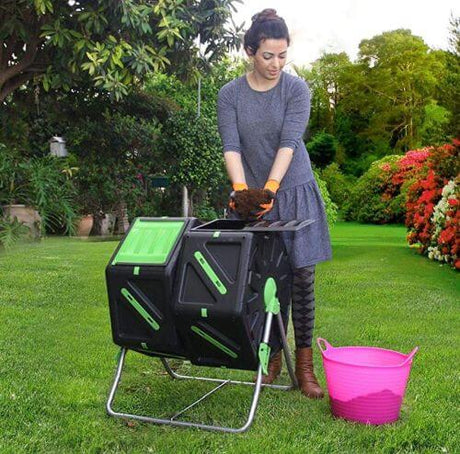 Lady using Composting Tumbler with pink bucket