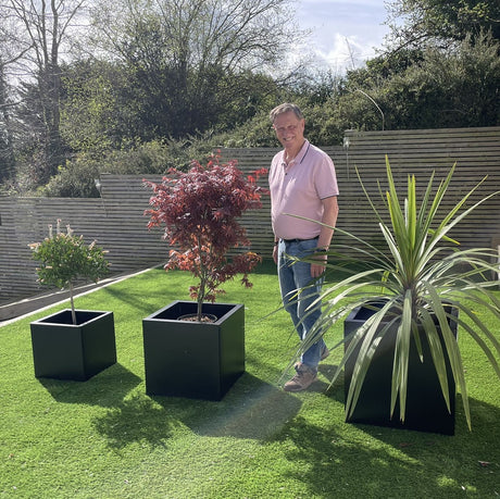 zinc black cube planters in garden with man