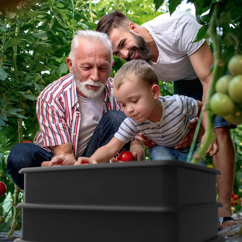 3 people filling wormery with vegetables looks like 3 generations