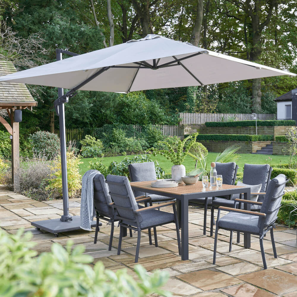 Grey Garden Table and chairs in garden with umbrella