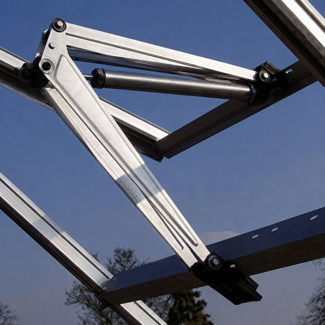 Close-up of a metal roof truss frame with aluminum beams, black brackets, and a blue sky background.