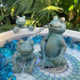 Frog-themed water fountain with decorative stones 