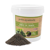 Seaweed soil enhancer in a 800g tub with a pile of natural seaweed granules.
