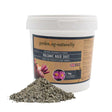 1 kg tub of volcanic rock dust soil improver with loose rock dust shown.