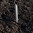 Metal stake driven into dark soil